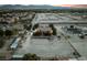 Aerial view of a property with a red house, outbuildings, and potential development land at 6931 Leon Ave, Las Vegas, NV 89131