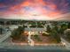 Expansive aerial view showcases the property's beautiful landscaping, horseshoe driveway, and peaceful residential setting at 6931 Leon Ave, Las Vegas, NV 89131