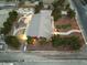 Expansive property featuring a red home, lush landscaping, a white fence, and a detached garage/shed at 6931 Leon Ave, Las Vegas, NV 89131