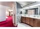Elegant bathroom featuring a dual sink vanity, marble-look accents, and ambient lighting at 6931 Leon Ave, Las Vegas, NV 89131