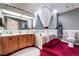 Luxurious bathroom with a soaking tub and a dual sink vanity with carpet at 6931 Leon Ave, Las Vegas, NV 89131