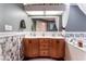 Bright bathroom with a dual sink vanity, and a soaking tub with marble-look accents at 6931 Leon Ave, Las Vegas, NV 89131