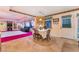 Cozy dining area with a dining table set for four, adjacent to a sunlit living space at 6931 Leon Ave, Las Vegas, NV 89131