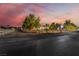 Gated property entrance providing privacy and security, enhanced by mature trees and landscape at 6931 Leon Ave, Las Vegas, NV 89131