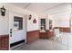 Front door and porch with white trim and beautiful lighting at 6931 Leon Ave, Las Vegas, NV 89131