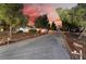 Beautiful single story home with a long driveway, landscaped yard, and charming exterior lighting at dusk at 6931 Leon Ave, Las Vegas, NV 89131