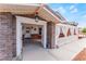 Inviting front porch with stone accents, a decorative fence, and charming landscaping at 6931 Leon Ave, Las Vegas, NV 89131
