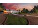 Charming home featuring a lush green lawn, well-manicured landscape, and inviting walkway with exterior lighting at 6931 Leon Ave, Las Vegas, NV 89131