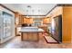 Bright kitchen with an island, stainless steel appliances, and tile flooring at 6931 Leon Ave, Las Vegas, NV 89131