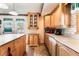 Kitchen with island, lots of cabinets, white counter tops and tile floors at 6931 Leon Ave, Las Vegas, NV 89131