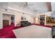 Spacious living room with plush carpet, tray ceiling, fireplace, and ample seating at 6931 Leon Ave, Las Vegas, NV 89131