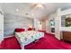 Bright main bedroom with carpet, and a decorative accent wall and attached bathroom at 6931 Leon Ave, Las Vegas, NV 89131