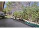 Scenic backyard with a rock-lined stream, lush greenery, and a stone path creating a peaceful oasis at 7012 Bright Springs Ct, Las Vegas, NV 89113