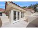 Balcony featuring glass double doors, tile rooftops, and ample sunlight, a perfect spot for relaxation at 7012 Bright Springs Ct, Las Vegas, NV 89113