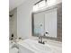 Bright bathroom with white cabinets, a decorative mirror, tile surround and a showerhead at 7012 Bright Springs Ct, Las Vegas, NV 89113
