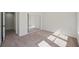 Bright bedroom with mirrored closet doors, light carpet, and a doorway leading to an adjacent room at 7012 Bright Springs Ct, Las Vegas, NV 89113