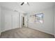Bedroom with neutral carpet, closet, ceiling fan and ample natural light streaming through a window at 7012 Bright Springs Ct, Las Vegas, NV 89113