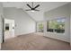 Large bedroom with vaulted ceilings, ceiling fan, backyard access, and an open floor plan at 7012 Bright Springs Ct, Las Vegas, NV 89113
