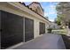 Rear exterior view showcasing a comfortable patio area with multiple sliding glass doors at 7012 Bright Springs Ct, Las Vegas, NV 89113