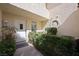Charming front entry with a white door and lush landscaping at 7012 Bright Springs Ct, Las Vegas, NV 89113
