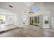 Open living space with vaulted ceilings, light floors, and a view of the kitchen at 7012 Bright Springs Ct, Las Vegas, NV 89113