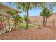 Beautiful backyard featuring artificial turf, desert landscaping, and charming water fountain at 7497 Alamo Ranch Ave, Las Vegas, NV 89179