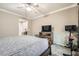 Bright bedroom with carpet features a ceiling fan and television for relaxation and comfort at 7497 Alamo Ranch Ave, Las Vegas, NV 89179