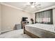 Comfortable bedroom features neutral paint, ceiling fan, carpet and a window for natural light at 7497 Alamo Ranch Ave, Las Vegas, NV 89179