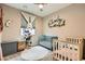 Charming Bedroom with hardwood floors, lots of light, a plush rug, and 2 cribs at 7497 Alamo Ranch Ave, Las Vegas, NV 89179