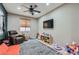 Spacious bonus room with neutral paint, ceiling fan and TV for relaxing and entertaining at 7497 Alamo Ranch Ave, Las Vegas, NV 89179