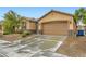 Inviting single-story home boasts an attached two-car garage, stone accents, and well-maintained front yard at 7497 Alamo Ranch Ave, Las Vegas, NV 89179