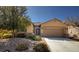 Charming single story home featuring desert landscaping and a two car garage with an decorative security door at 7497 Alamo Ranch Ave, Las Vegas, NV 89179
