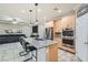 Open kitchen featuring an island with barstool seating, stainless appliances, and view to living area at 7497 Alamo Ranch Ave, Las Vegas, NV 89179