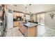 Modern kitchen featuring granite countertops, stainless steel appliances, and a stylish island with bar seating at 7497 Alamo Ranch Ave, Las Vegas, NV 89179