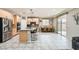 Bright kitchen with stainless steel appliances, granite countertops, and an adjacent dining area at 7497 Alamo Ranch Ave, Las Vegas, NV 89179