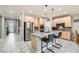 Bright kitchen with stainless steel appliances, granite countertops, and a center island with barstool seating at 7497 Alamo Ranch Ave, Las Vegas, NV 89179