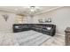 Comfortable living room with a large gray sectional, neutral walls, and a ceiling fan at 7497 Alamo Ranch Ave, Las Vegas, NV 89179