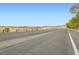 Scenic street view showcasing the natural beauty and open spaces surrounding the property at 7497 Alamo Ranch Ave, Las Vegas, NV 89179