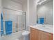 Bathroom features a vanity, tiled shower, and toilet creating a functional space at 7624 Fruit Dove St, North Las Vegas, NV 89084