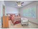 Comfortable bedroom with a large bed, ceiling fan, and bright windows for natural light at 7624 Fruit Dove St, North Las Vegas, NV 89084