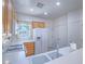 Functional kitchen with oak cabinets, white appliances, and convenient access to storage spaces at 7624 Fruit Dove St, North Las Vegas, NV 89084