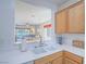 Bright kitchen featuring a dual sink and pass-through to the living room with natural light at 7624 Fruit Dove St, North Las Vegas, NV 89084
