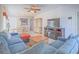 Cozy living room showcases comfortable seating, a fireplace, and seamless flow to the dining area at 7624 Fruit Dove St, North Las Vegas, NV 89084