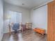 Functional office space featuring wood floors, a work desk, and natural light from the window at 7624 Fruit Dove St, North Las Vegas, NV 89084