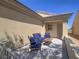 Cozy outdoor patio with comfortable seating and a small table, perfect for relaxation at 7624 Fruit Dove St, North Las Vegas, NV 89084