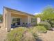 Inviting covered patio area with lounge seating and landscaped backyard at 7624 Fruit Dove St, North Las Vegas, NV 89084
