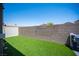 Lush backyard featuring artificial turf, brick wall, and white privacy fence at 7890 Aurora Sky St # 1, North Las Vegas, NV 89084