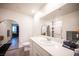 Bright bathroom featuring modern vanity, sink, and a shower with accessibility features at 7890 Aurora Sky St # 1, North Las Vegas, NV 89084