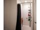 Modern bathroom featuring a tile shower with grab bar and a built-in seat at 7890 Aurora Sky St # 1, North Las Vegas, NV 89084