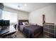 Comfortable bedroom featuring natural light, desk area, and wood-look flooring at 7890 Aurora Sky St # 1, North Las Vegas, NV 89084